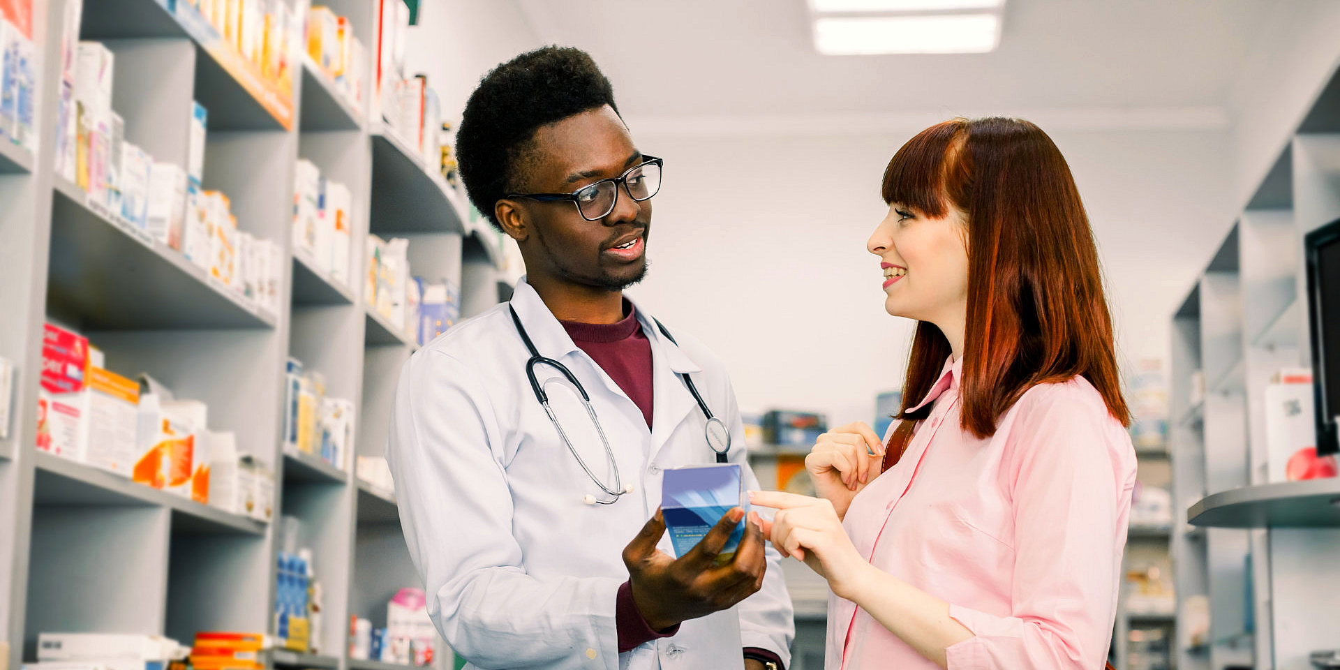 a male pharmacist with a customer